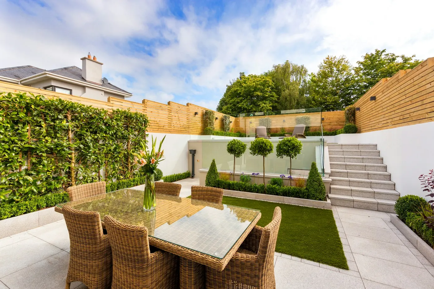 Clean, well-maintained residential perimeter and updated roofing fixtures on a clear day